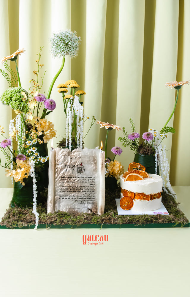 Gourmet summer birthday cake with dried orange slices and white frosting from Gateau Gourmet Cafe