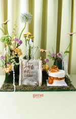 Gourmet summer birthday cake with dried orange slices and white frosting from Gateau Gourmet Cafe
