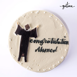 Graduation cake for boys featuring a graduate figure and personalized text for celebration