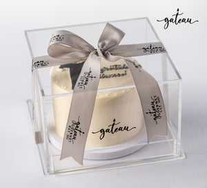Elegant graduation cake for boys in a clear box with a stylish ribbon from Gateau Gourmet Cafe