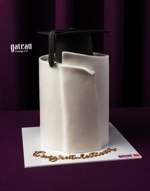 Graduation cake from Gateau Gourmet Cafe featuring a black graduation cap with diploma design