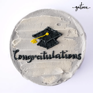 Gateau Gourmet Cafe Graduation Celebration Cake with a black cap and congratulations text on grey frosting