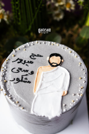 Hajj celebration cake by Gateau Gourmet Cafe with icing figure in traditional Ihram attire and decorative pearls