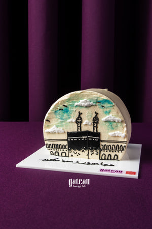 Gateau Gourmet Cafe Hajj celebration cake with Kaaba design and decorative clouds on white base