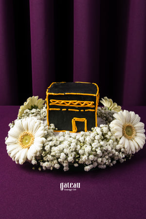 Hajj Mubarak cake for gifting featuring a black Kaaba design surrounded by white flowers from Gateau Gourmet Cafe