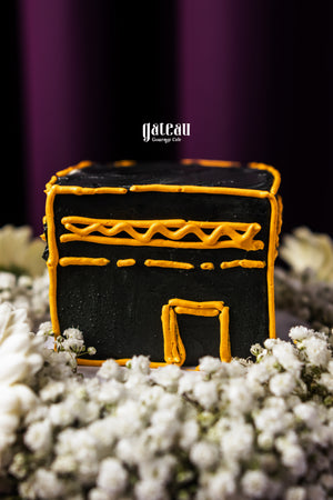 Gateau Gourmet Cafe Hajj Mubarak cake for gifting shaped like the Kaaba with black and orange icing