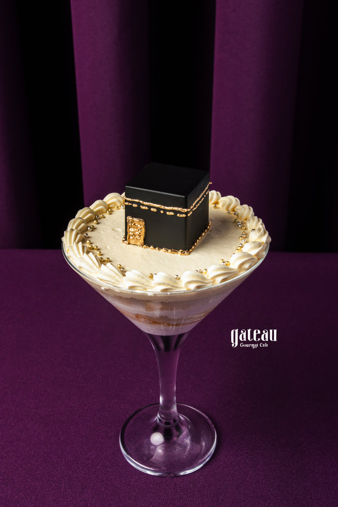 Hajj themed cake goblet from Gateau Gourmet Cafe with cream and black cube decoration in a glass