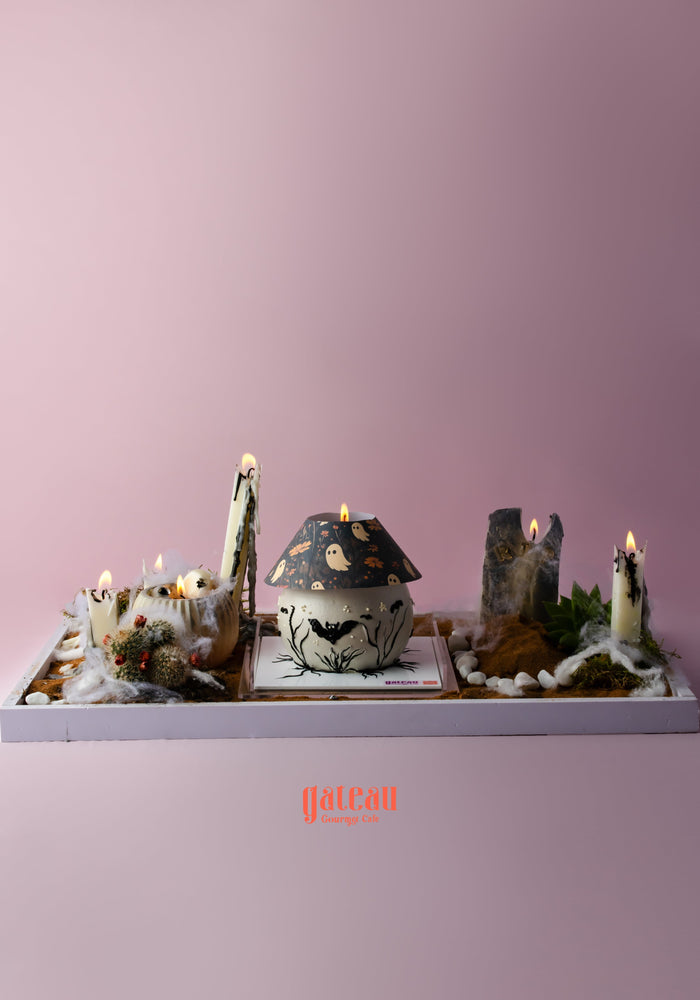 Spooky Halloween cake with candle arrangement featuring festive decorations and an elegant design