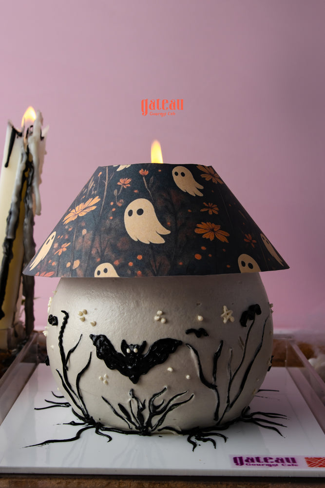Halloween cake with candle arrangement featuring spooky designs and ghostly decorations