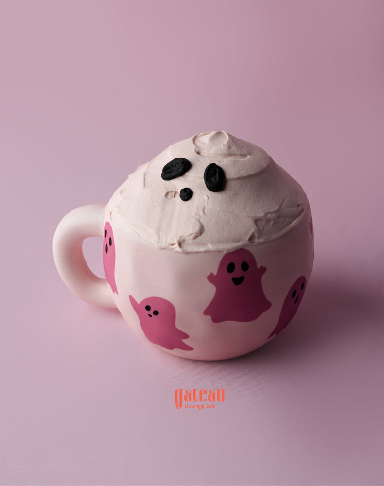 Halloween teacup cake with ghost design and creamy frosting for festive celebrations