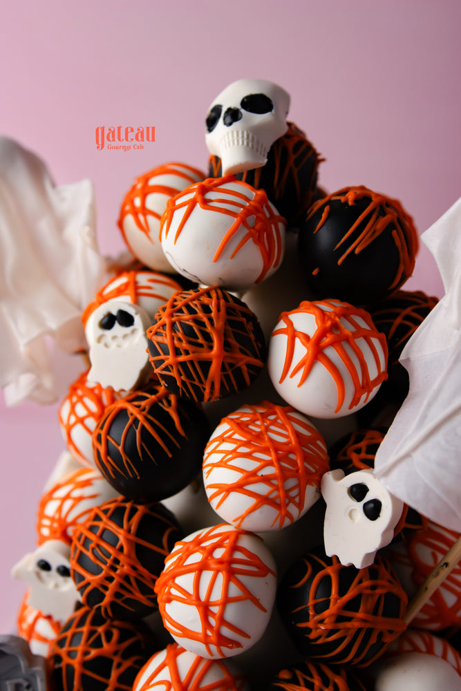 Halloween truffle tower featuring black and white truffles with spooky designs and decorations