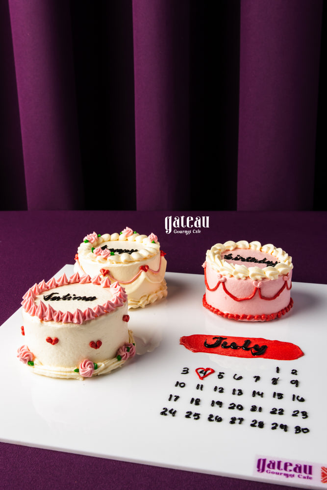 Handcrafted birthday cake for celebration by Gateau Gourmet Cafe with floral decorations and personalized names