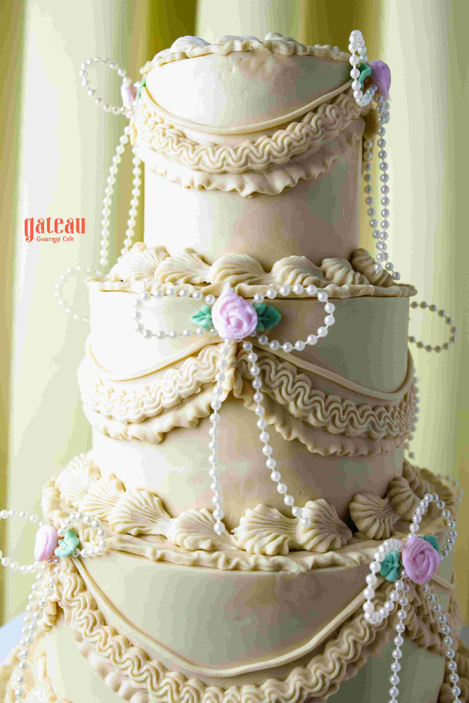 Handcrafted wedding cake near me by Gateau Gourmet Cafe with elegant white icing and pearl decorations