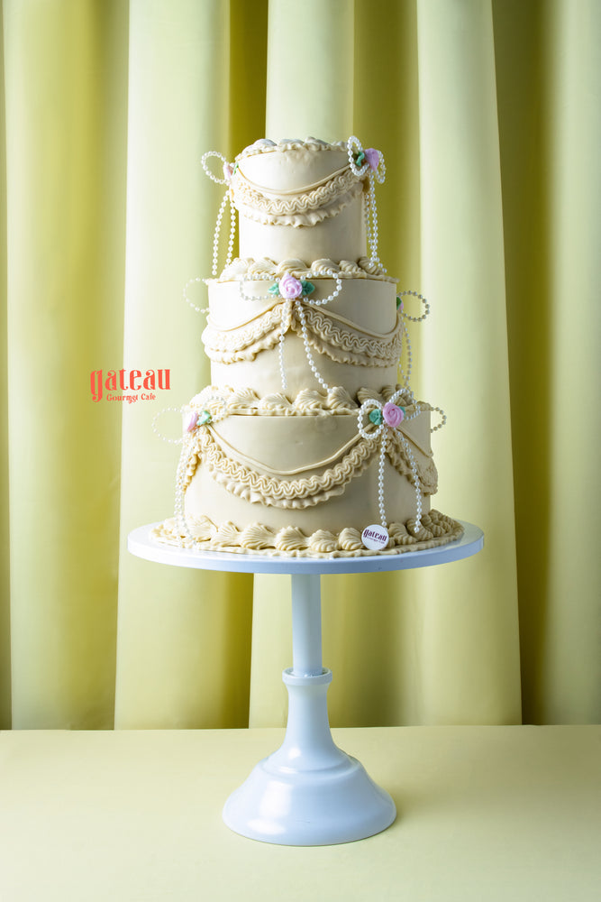 Handcrafted wedding cake near me by Gateau Gourmet Cafe with elegant cream layers and floral decorations