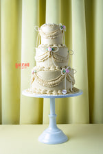 Handcrafted wedding cake near me by Gateau Gourmet Cafe with elegant cream layers and floral decorations