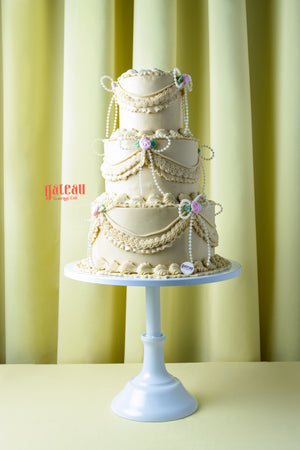 Handcrafted wedding cake near me by Gateau Gourmet Cafe with elegant cream layers and floral decorations
