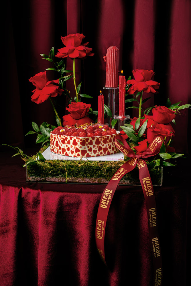 Gateau Gourmet Cafe heart shape raspberry tart decorated with fresh raspberries and surrounded by red roses and candles
