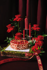 Heart shape raspberry tart from Gateau Gourmet Cafe decorated with fresh raspberries and surrounded by red roses and candles