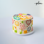 Hippie sticker cake from Gateau Gourmet Cafe decorated with colorful smiley faces and flowers