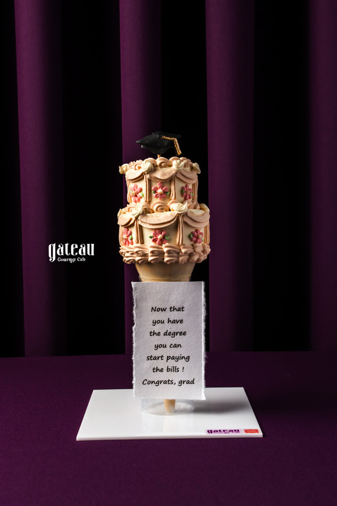 Ice Cream Cone Graduation Cake with floral details and a graduation cap for celebrating achievements