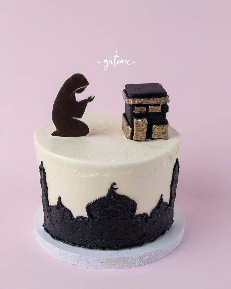 Kaaba themed cake by Gateau Gourmet Cafe with praying figure and mosque silhouette decoration