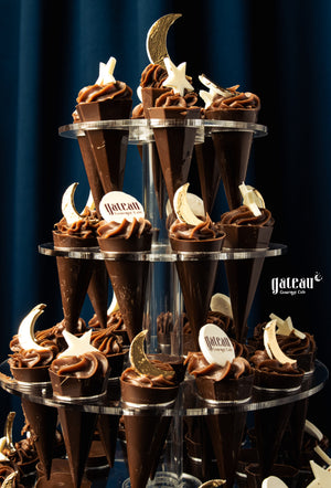 Kunafa Pistachio Chocolate Tower displayed at Gateau Gourmet Cafe with chocolate cones and decorative toppings