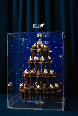 Kunafa Pistachio Chocolate Tower displayed elegantly at Gateau Gourmet Cafe in a clear acrylic case