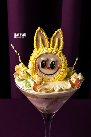 Colorful Labubu cake with cute bunny design and decorative flowers at Gateau Gourmet Cafe