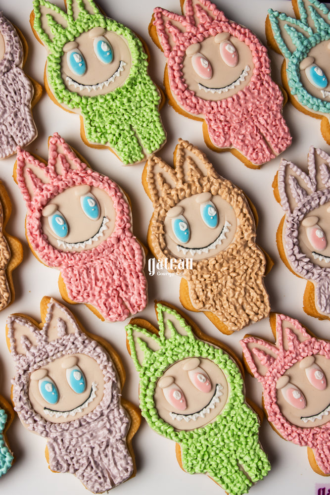 Colorful Labubu character cookies decorated with pink, green, purple, and blue frosting from Gateau Gourmet Cafe