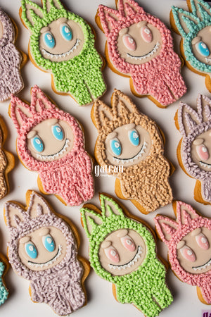 Colorful Labubu character cookies decorated with pink, green, purple, and blue frosting from Gateau Gourmet Cafe