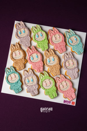 Colorful Labubu character cookies from Gateau Gourmet Cafe decorated with pastel icing in various colors