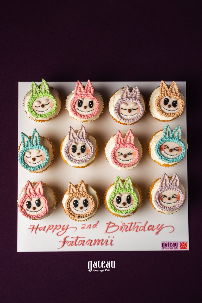 Labubu character cupcakes from Gateau Gourmet Cafe arranged on a birthday message board