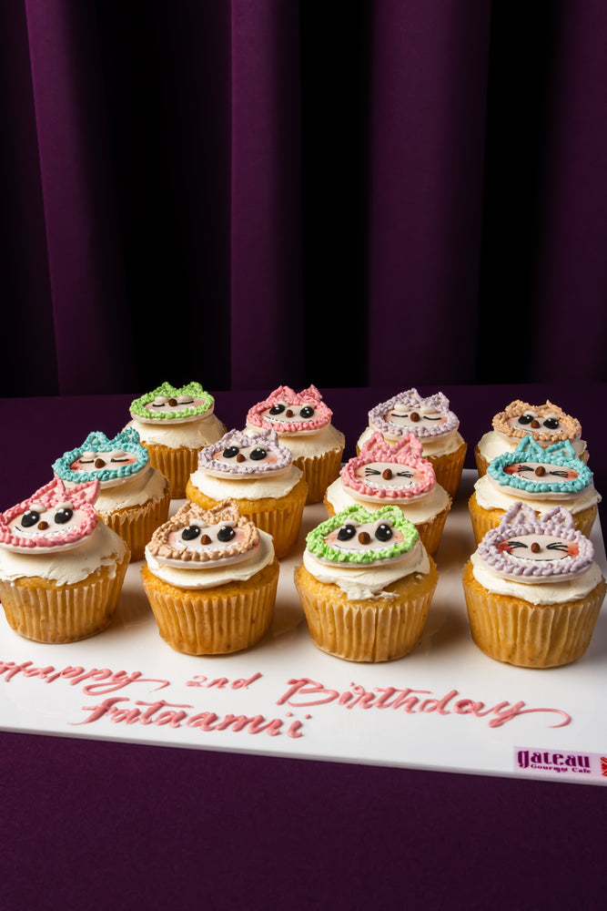 Gateau Gourmet Cafe Labubu character cupcakes with colorful icing and cute faces on white board