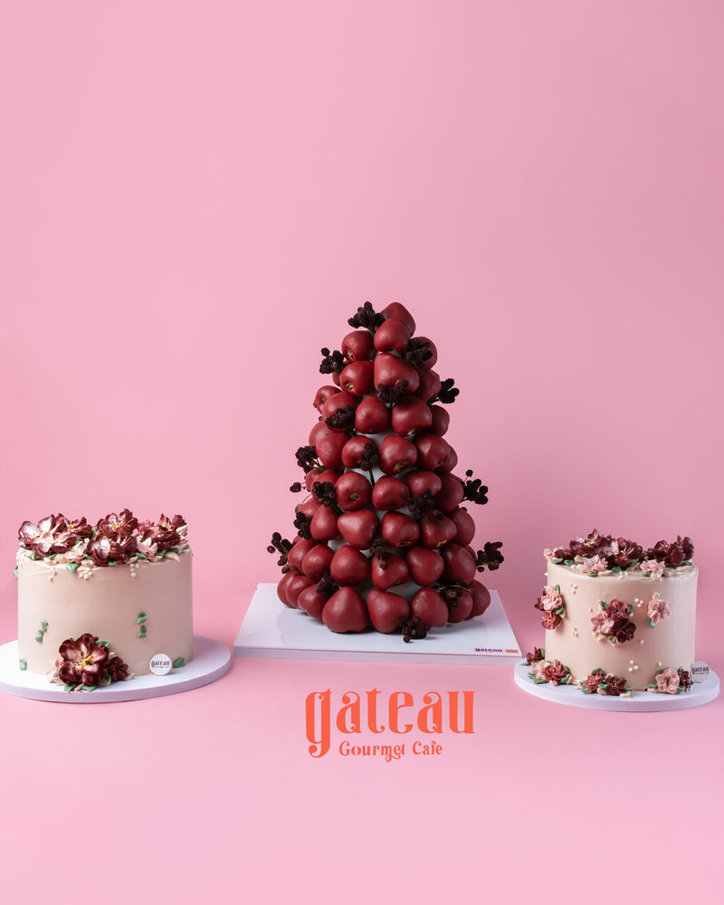 Three elegant cakes from Gateau Gourmet Cafe featuring a luxury strawberry cake for parties with floral decorations