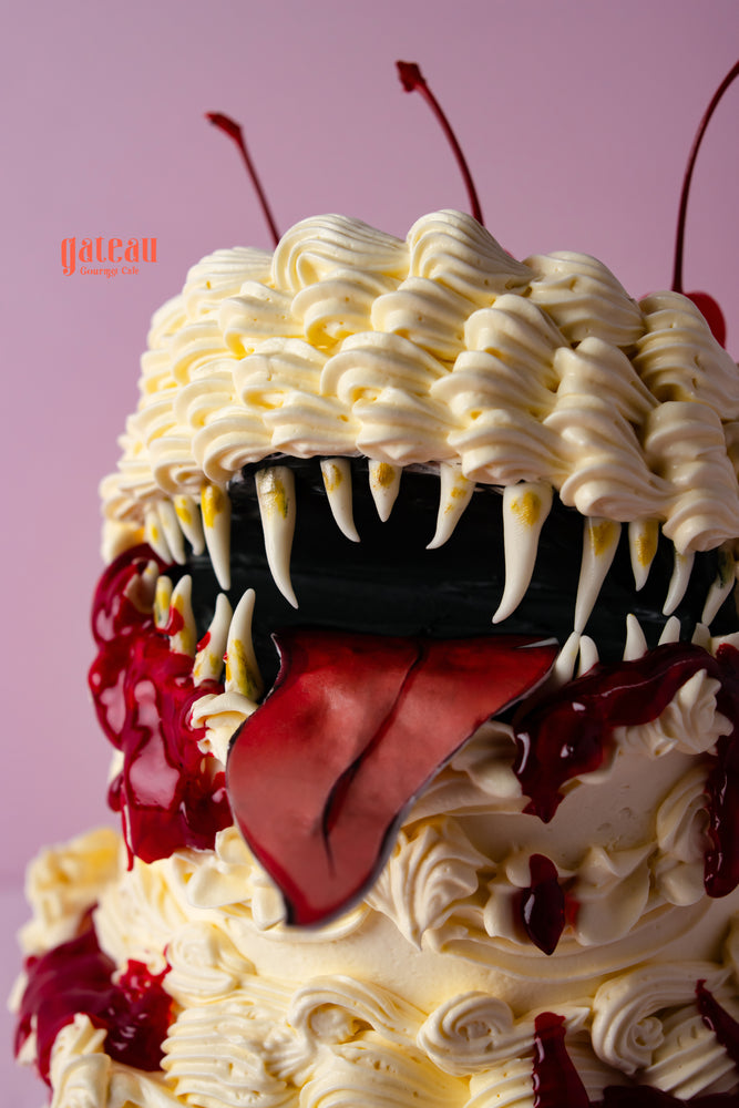 Gateau Gourmet mimic monster cake with creamy frosting, sharp fangs, and dripping red sauce