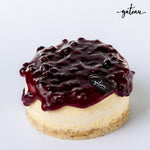 Gateau Gourmet Cafe mini blueberry cheesecake topped with rich blueberry sauce on crumbly crust