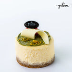 Gateau Gourmet Cafe mini pistachio cheesecake dessert topped with white chocolate curl and nuts
