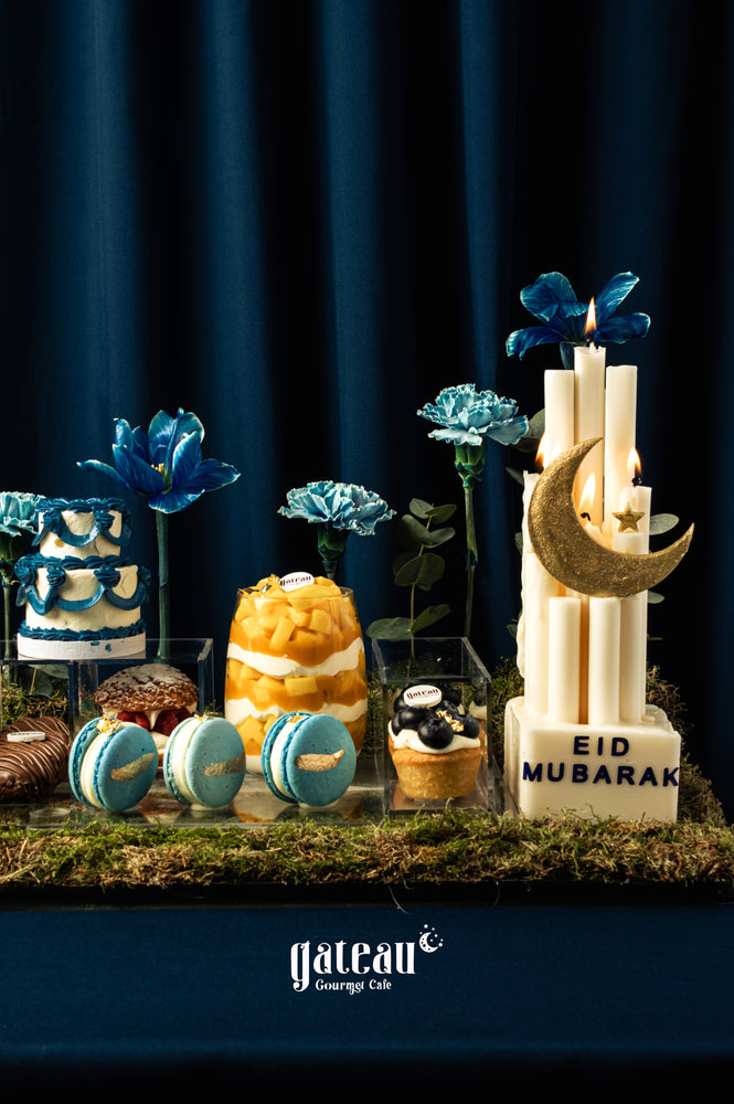 Gorgeous mini sweet dessert tray for Eid featuring colorful cakes, macarons, and decorative flowers