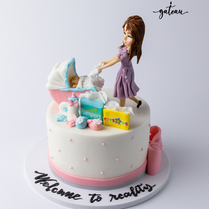 Mommy-and-baby-day-out-cake featuring a figurine of a mother with a baby stroller and playful decorations
