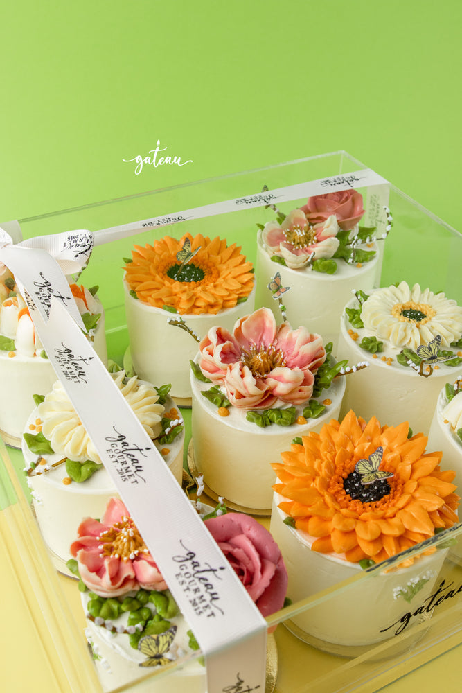 Gateau Gourmet Cafe mono floral cake designs with colorful flower decorations in clear box