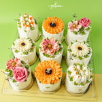 Gateau Gourmet Cafe mini cakes featuring colorful mono floral cake designs with detailed flower decorations