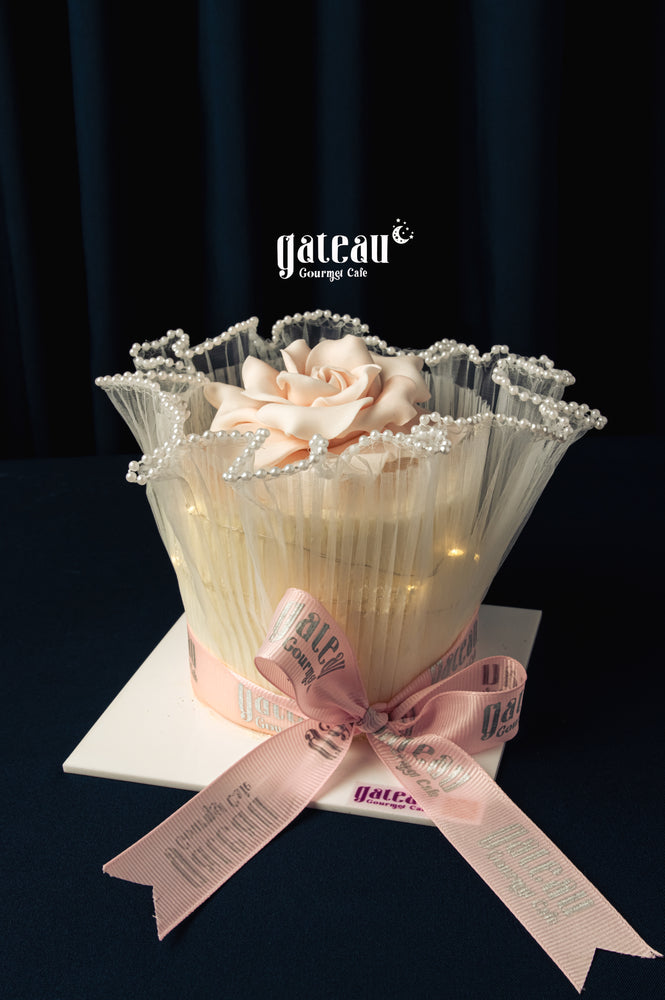 Elegant Gateau Gourmet Cafe cake with delicate flower and pink ribbon for Mother's Day cake delivery