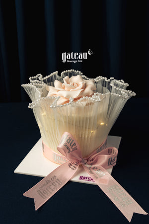 Elegant Gateau Gourmet Cafe cake with delicate flower and pink ribbon for Mother's Day cake delivery