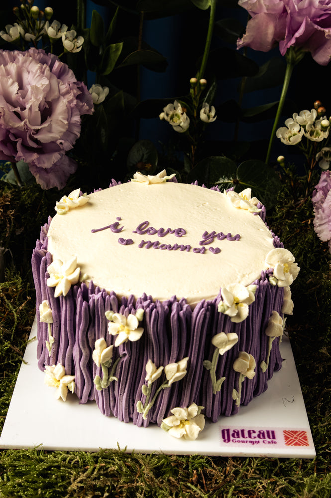 Mother's Day cake delivery with purple floral design and I love you Mom message from Gateau Gourmet Cafe