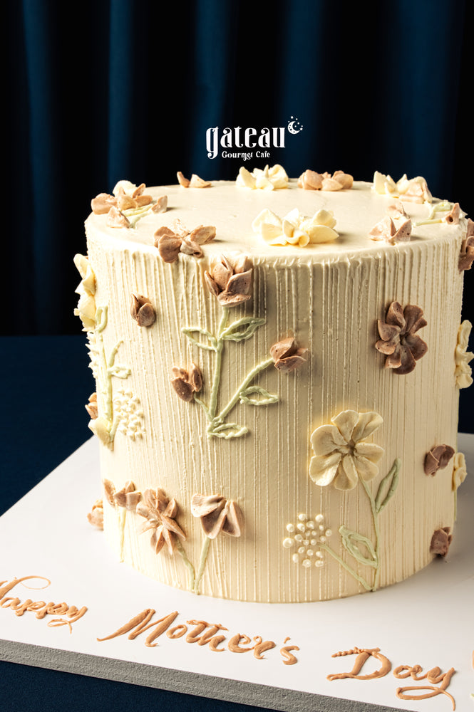 Gateau Gourmet Cafe Mother's Day cakes decorated with intricate floral icing on cream frosting