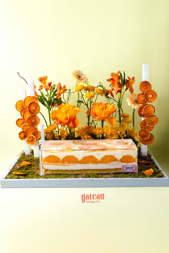 Gateau Gourmet Cafe orange flavored dessert for summer cake decorated with orange flowers and dried orange slices