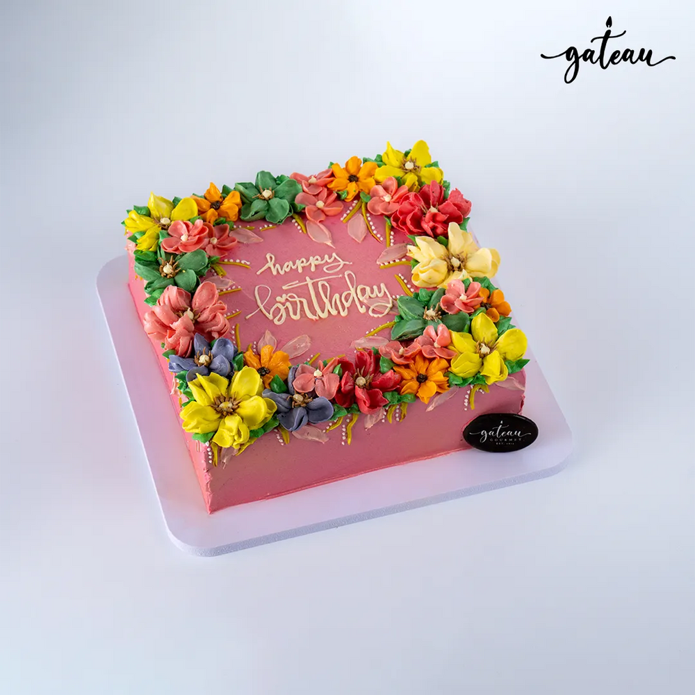 Colorful personalized birthday cake delivery adorned with flowers from Gateau Gourmet Cafe