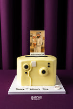 Personalized cake for birthday shaped like a vintage camera with a custom photo topper from Gateau Gourmet Cafe