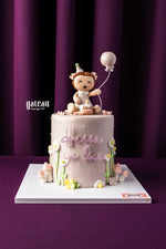Personalized cakes for birthdays by Gateau Gourmet Cafe featuring a pink birthday cake with a bear and balloon topper