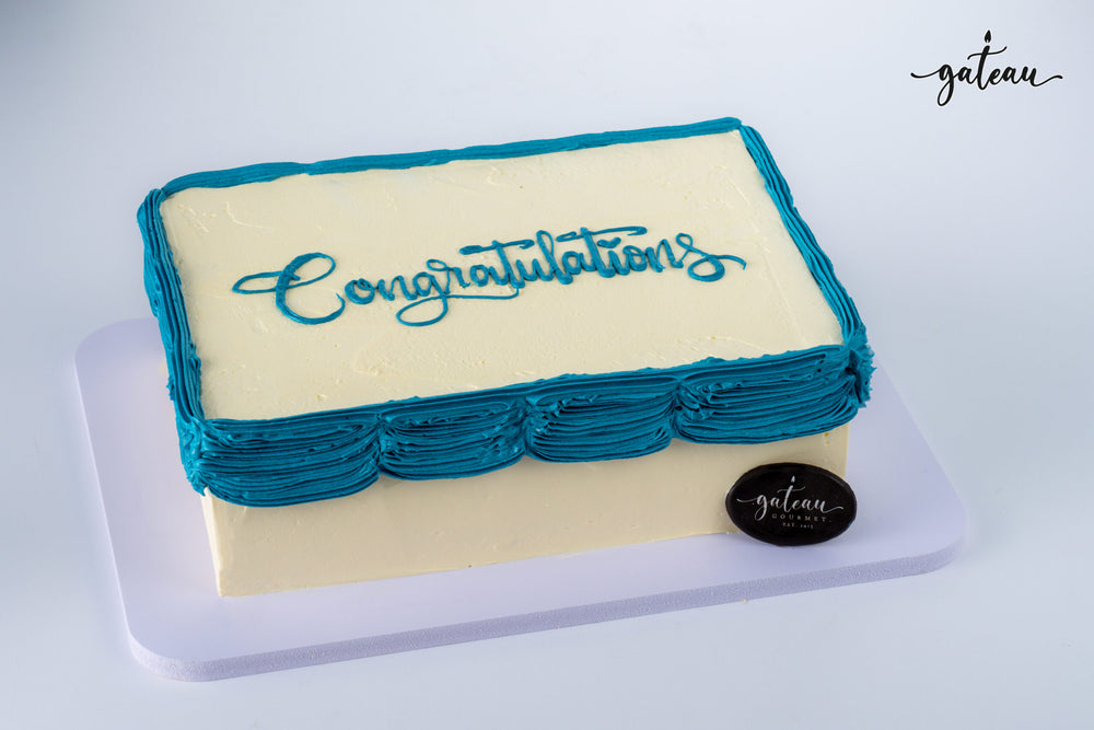 Gateau Gourmet Cafe personalized corporate cake design with white frosting and blue decorations saying Congratulations